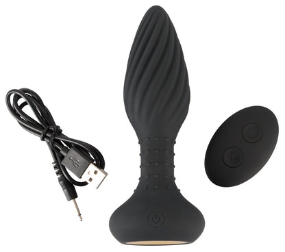 ANOS rotierender Analplug mit Vibration und Remote – Produktansicht mit Ladekabel, Remote und Zubehör