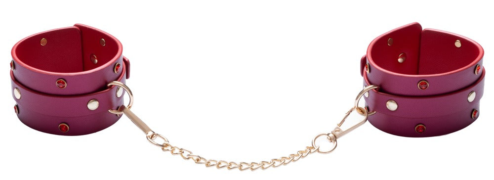 Pinkfarbene Fußfesseln mit goldfarbener Verbindungskette aus dem Bad Kitty Bondage-Set