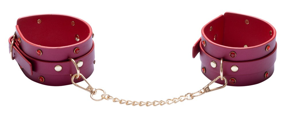 Pinkfarbene Handfesseln mit goldfarbener Verbindungskette aus dem Bad Kitty Bondage-Set