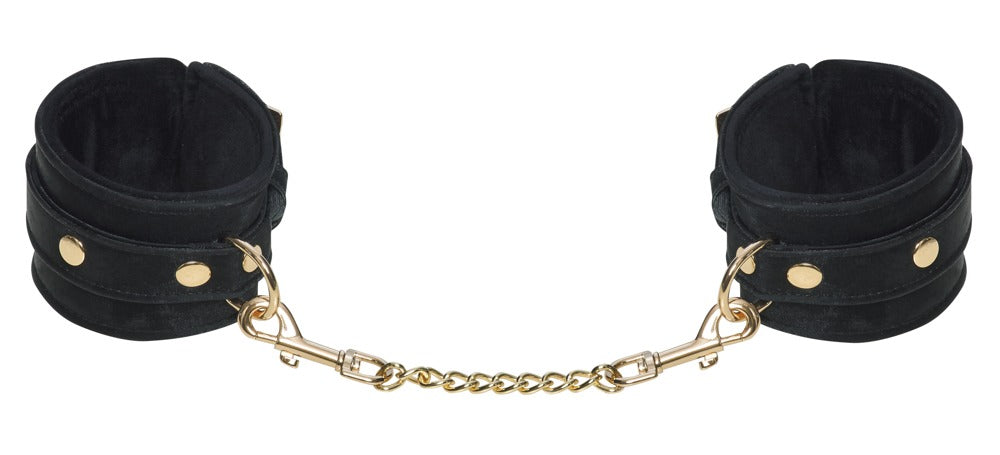 Detailansicht der Bad Kitty Handfesseln in Schwarz mit Gold-Details