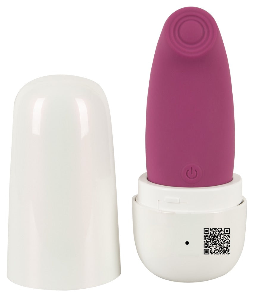 beau coeur OMINO Thumping Stimulator in geöffnetem weißen Ladecase zur geschützten Aufbewahrung und mobilen Aufladung