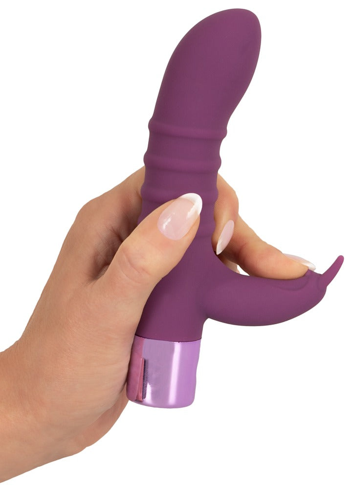 Elegant Series Rabbit Vibe in der Hand mit sichtbarem Schaft und äußerem Klitorisstimulator