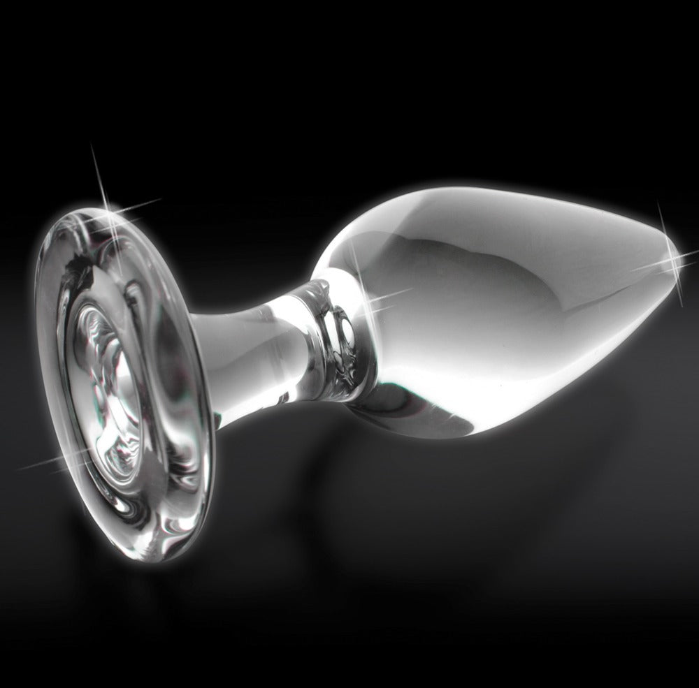 Icicles No. 26 transparenter Glas-Analplug mit glatter Oberfläche, länglicher Tropfenform und rundem Standfuß in horizontaler Seitenansicht vor schwarzem Hintergrund – erhältlich bei Evoria Care