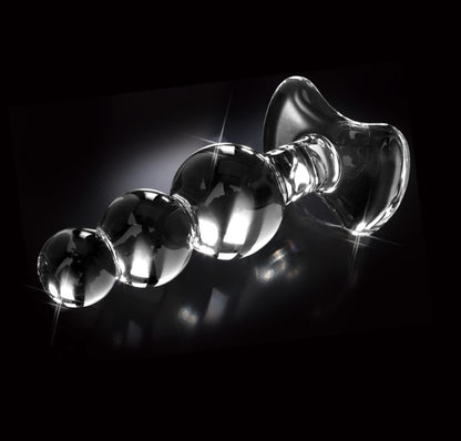 Icicles No. 47 transparenter Premium-Glasplug mit drei unterschiedlich großen Kugeln und glatter Glasoberfläche in horizontaler Seitenansicht vor schwarzem Hintergrund – erhältlich bei Evoria Care