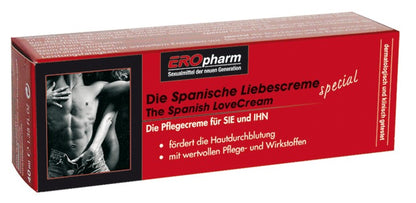 JOYDIVISION Spanische LiebesCreme – längliche rote Originalverpackung der stimulierenden Intimcreme für Sie und Ihn mit schwarzem Produktetikett, weißer Beschriftung und dekorativer Produktabbildung in schräger Ansicht auf weißem Hintergrund – erhältlich bei Evoria Care