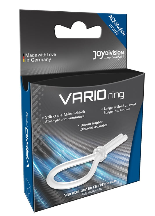 JOYDIVISION VARIOring – transparenter flexibler Penisring mit verstellbarer Schlaufe und länglichen Enden neben der schwarz-blauen Originalverpackung mit VARIOring Produktbeschriftung – erhältlich bei Evoria Care