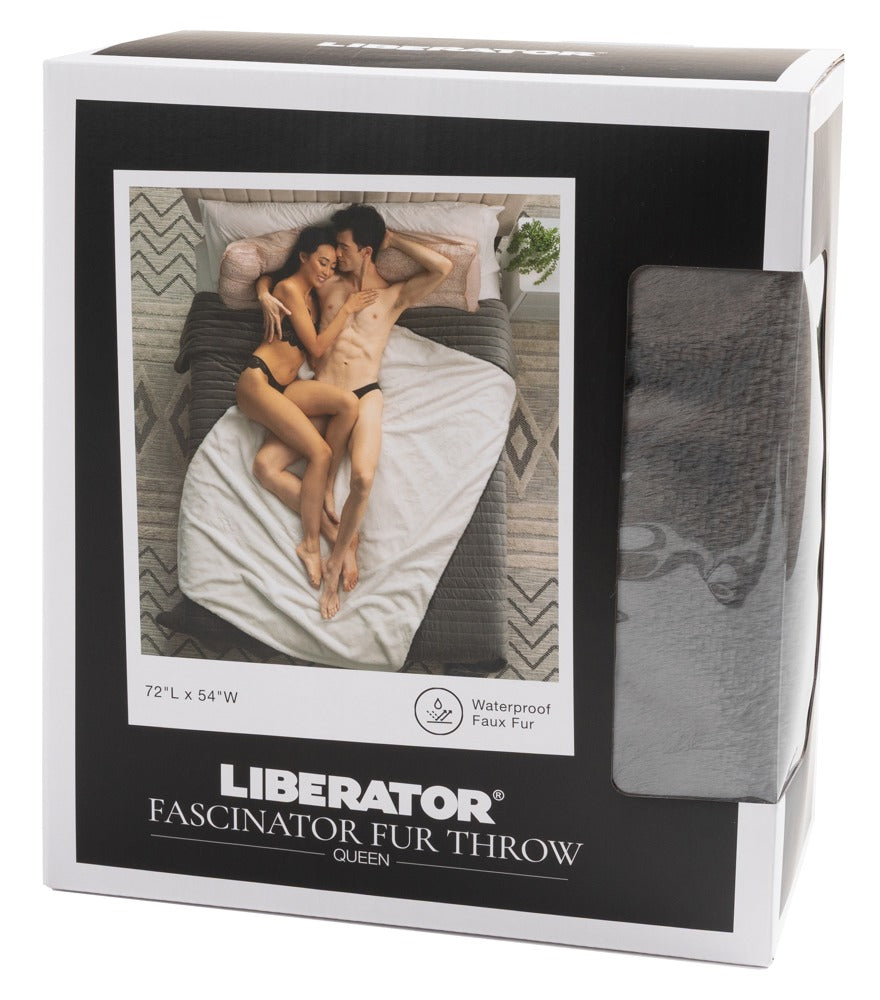 Liberator Faux-Fur Fascinator Liebesdecke in Schwarz und Grau mit weicher Kunstfelloberfläche, zusammengefaltet in transparenter Originalverpackung mit schwarzem Liberator Etikett und Paarmotiv in frontaler Ansicht – erhältlich bei Evoria Care