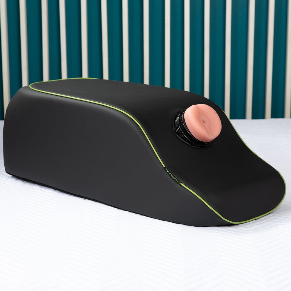 Liberator Mount on a Mission – schwarzes Positionierungskissen mit grünen Ziernähten und integrierter Toy-Halterung, aufgestellt vor türkisfarbenem Hintergrund mit einem eingesetzten schwarzen Sextoy – erhältlich bei Evoria Care