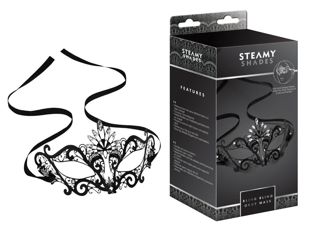 STEAMY SHADES Bling Bling Orgi Mask schwarze Augenmaske mit dekorativen silberfarbenen Schmuckelementen, filigranen Verzierungen und schwarzen Befestigungsbändern, dargestellt neben der schwarzen Originalverpackung – erhältlich bei Evoria Care