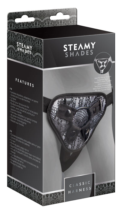 STEAMY SHADES Classic Harness verstellbarer Strap-on Harness in schwarzer Originalverpackung mit Abbildung des schwarzen Gurtsystems, gemusterter Frontpartie und STEAMY SHADES Markenlogo – erhältlich bei Evoria Care