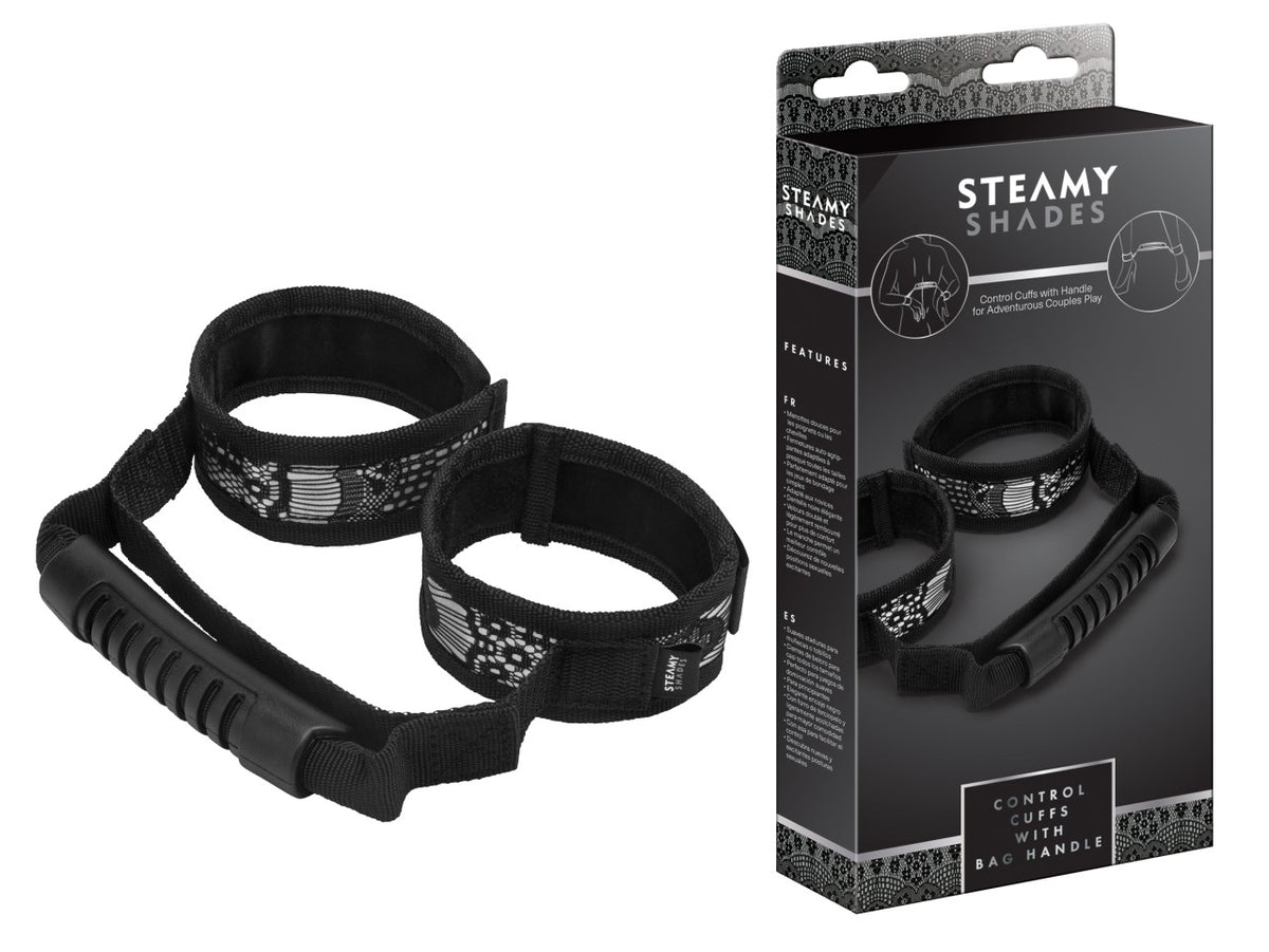 STEAMY SHADES Control Cuffs gepolsterte Hand- und Fußfesseln in Schwarz mit zwei verstellbaren Manschetten, weicher Polsterung und breitem Kontrollgriff, dargestellt neben der schwarzen Originalverpackung – erhältlich bei Evoria Care