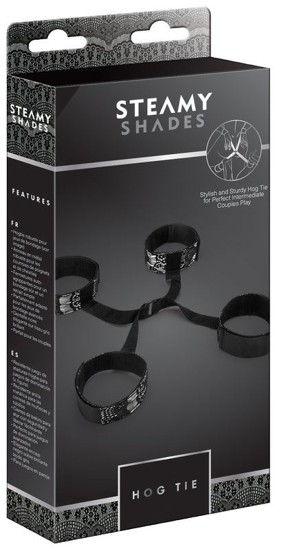 STEAMY SHADES Hog Tie Hand- und Fußfesseln mit Verbindungsring in schwarzer Originalverpackung mit Abbildung der vier Fesselmanschetten, des zentralen Verbindungsrings und STEAMY SHADES Markenlogo – erhältlich bei Evoria Care