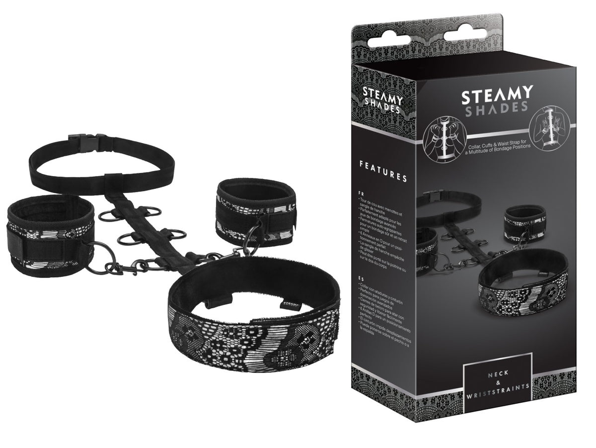 STEAMY SHADES Neck & Wriststraints schwarzes Fesselset mit Halsmanschette, zwei Handfesseln, breitem Hüftgurt und silberfarbenen Verbindungselementen, dargestellt neben der schwarzen Originalverpackung – erhältlich bei Evoria Care