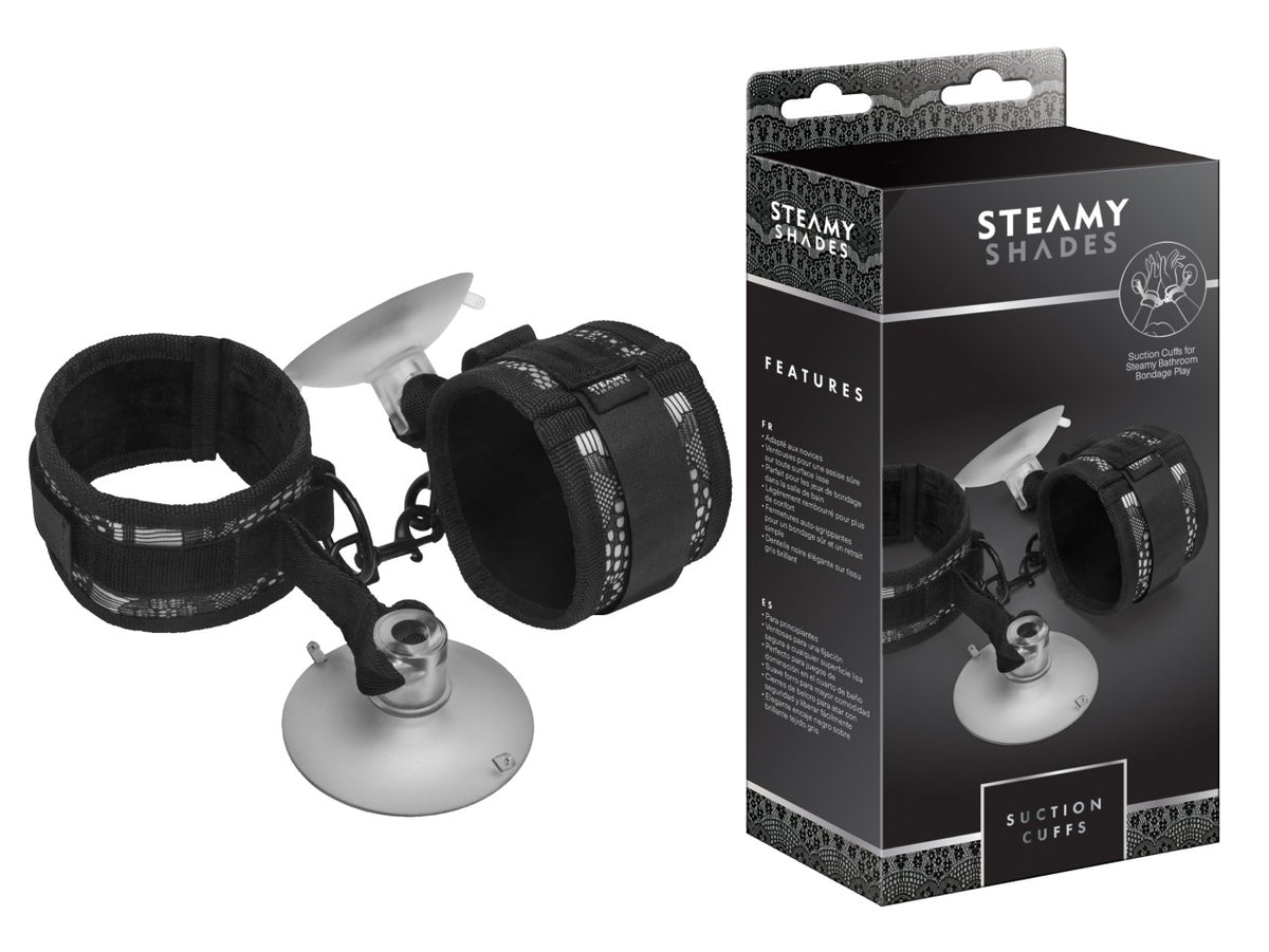 STEAMY SHADES Suction Cuffs gepolsterte Fesseln in Schwarz mit zwei verstellbaren Manschetten, silberfarbenen Verbindungselementen und transparenten Saugnäpfen, dargestellt neben der schwarzen Originalverpackung – erhältlich bei Evoria Care