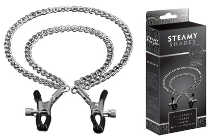 STEAMY SHADES verstellbare Nippelklemmen in Schwarz mit zwei silberfarbenen Metallketten, verstellbaren Klemmmechanismen und Metallringen, dargestellt neben der schwarzen Originalverpackung – erhältlich bei Evoria Care