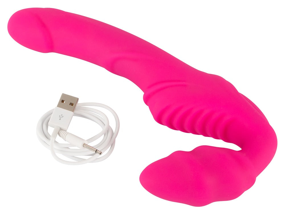 You2Toys Vibrating Strapless Strap-On in Pink – liegende Produktansicht mit separat dargestelltem Zubehör – erhältlich bei Evoria Care