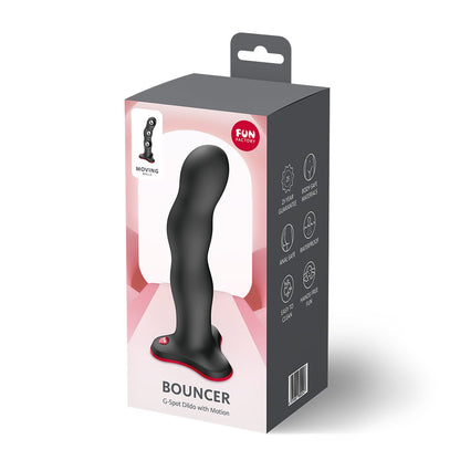 FUN FACTORY BOUNCER Dildo in Schwarz mit rotem Saugfuß neben der Originalverpackung