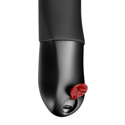 FUN FACTORY STRONIC REAL Premium-Pulsator in Schwarz mit Detailansicht des Griffendes und Ladeanschlusses