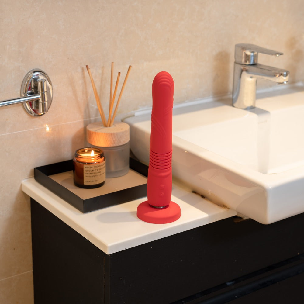 Lovense Gravity in eleganter Badezimmer-Szene mit rotem Silikon-Design