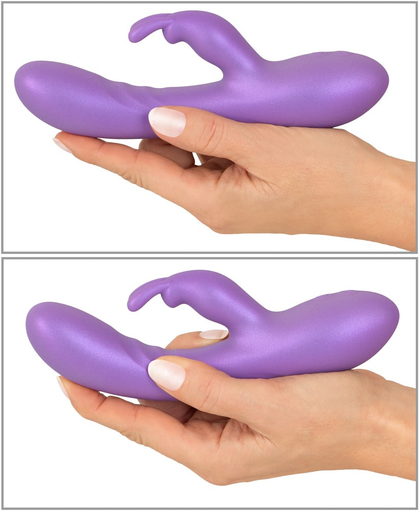 Sweet Smile Flexible Rabbit Vibrator in Lila – Größenvergleich in einer Hand mit geschwungenem Schaft und seitlichem Stimulationsarm