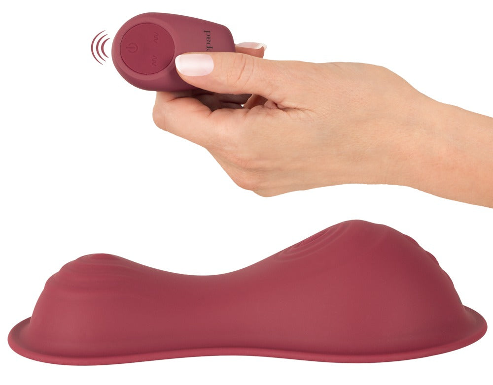 vibepad intense 2 mit kompakter Fernbedienung in der Hand zur kabellosen Steuerung