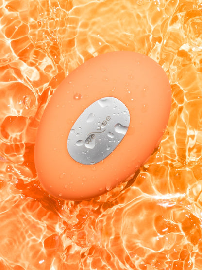 We-Vibe Temp Auflegevibrator in Orange auf leuchtendem Hintergrund