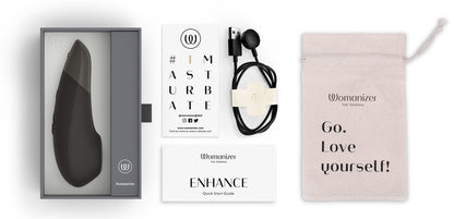 Womanizer Enhance Verpackung mit Zubehör und USB-Ladekabel