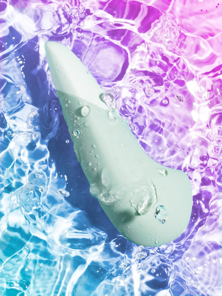 Womanizer Vibe Vibrator mit wasserinspiriertem Hintergrund